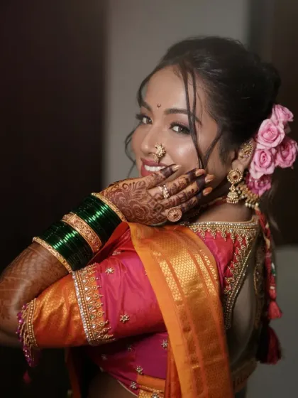 A playful and happy shot showing the beautiful floral bun and the bride's infectious smile.