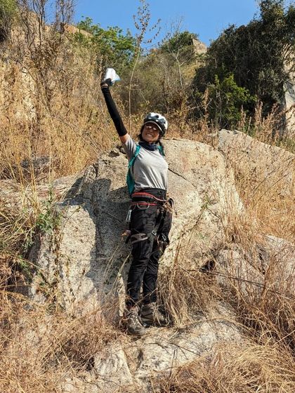 Shivani celebrating after a successful climb, chalk bag in hand. Her journey from learning skills to falling in love with the sport itself is a common one in our community.
