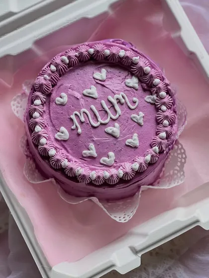 Another lovely bento cake for Mother's Day, this time in a pretty shade of purple with delicate piping and heart details.