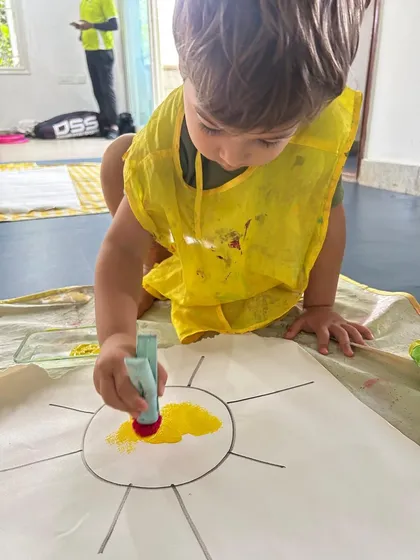 I paint, I learn. Even our youngest learners in the Independent Toddler Program get to express themselves through messy art. This activity is not just about painting a sun; it's about exploring color, texture, and the joy of creation.