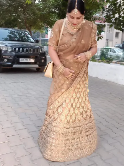 A sophisticated gold lehenga with intricate embroidery. This outfit is perfect for a bride who wants a glamorous and elegant look for her reception.