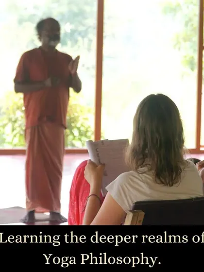 A student listens intently during a yoga philosophy lecture. Our courses delve into the deeper realms of yogic texts and concepts, providing a rich context that goes far beyond the physical asanas.