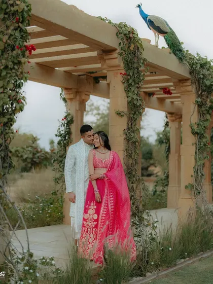 A perfect moment at Suryagarh, Jaisalmer, where a peacock decided to join Kajal and Ram's couple shoot. This unplanned guest added a touch of royal Rajasthani charm to their romantic portrait.