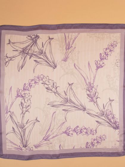 A flat-lay of the lavender floral pocket square, detailing the delicate line-art pattern.