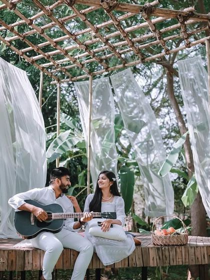 A wide shot of the beautiful bohemian-themed setup, showing the full context of the romantic picnic scene.