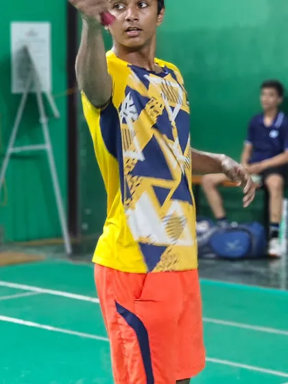 A young player at our academy prepares to serve, focusing on technique and precision.