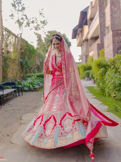 A bride's walk towards her future is a moment of grace and beauty. I captured this full-length shot of Yashika to showcase her stunning lehenga and the elegance of her bridal entry.
