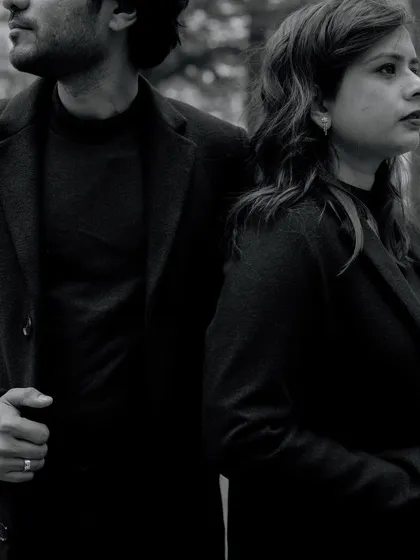 A moody black and white portrait of a couple in the Manali forest. The serious expressions and dark tones create a dramatic and cinematic feel.