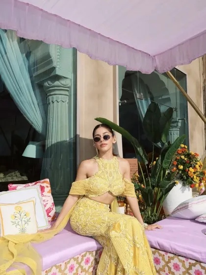 A sunshine-hued embellished sharara set with a daring halter neckline and floor-sweeping sleeves that move like poetry.