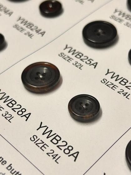 The right button can transform a garment. We offer a wide selection of high-quality buttons in various sizes and materials to perfectly match your chosen fabric and style.