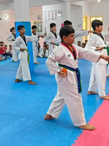 Students practicing a middle punch during their forms.