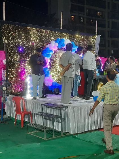 A birthday cake-cutting ceremony on the stage I set up. The sparkling backdrop with blue and white balloons looks great in photos.