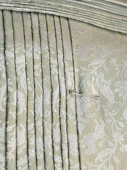 A safety pin marks the spot on these perfect pleats, a small but crucial detail I teach in my classes.