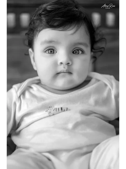 A striking black and white portrait of baby Anika. The simplicity of the edit draws all the attention to her beautiful, expressive eyes and soft features.