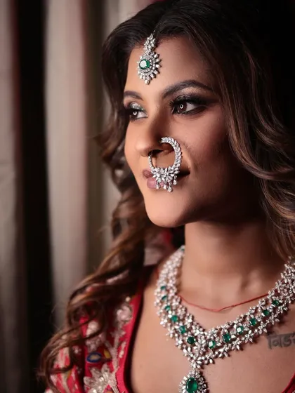 A stunning portrait of my bride, radiant in red. Her look is completed with a beautiful diamond nath and emerald jewellery.