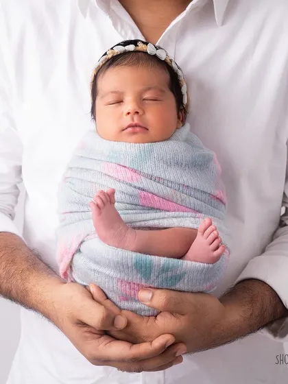 A sweet baby girl, known as "Golgappa" by her loving family. This photo captures her perfectly wrapped and content.