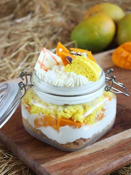 Our Mango Crumble Jar Cake, featuring layers of fresh mango, cream, and a delicious crumble for added texture.
