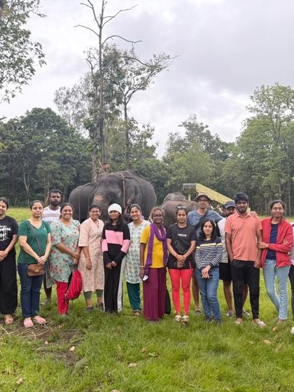 Another group photo with an elephant statue, capturing a fun moment during our trip to the Nagarahole region.