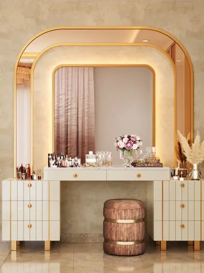 A dressing table should be a personal statement piece. This custom vanity unit features a layered, backlit arched mirror with gold trim, providing both perfect lighting and a touch of art-deco glamour to the master bedroom suite.