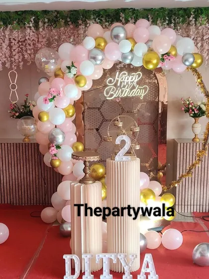 A beautiful ring decoration with a rose gold metallic arch. The pink, white, and gold balloons complement the arch perfectly for a very chic and modern look.