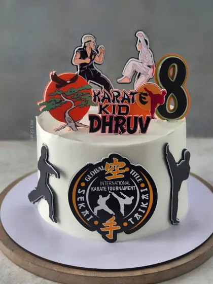 A powerful Karate Kid-themed cake for an 8th birthday. This Mocha Orange cake is decorated with karate silhouettes and a tournament logo.