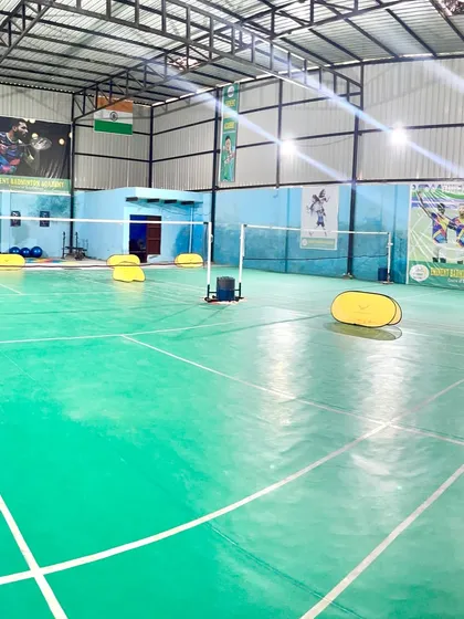 This perspective shows the depth of our badminton hall and the consistent, bright lighting across all playing areas, ensuring no shadows interfere with your game.