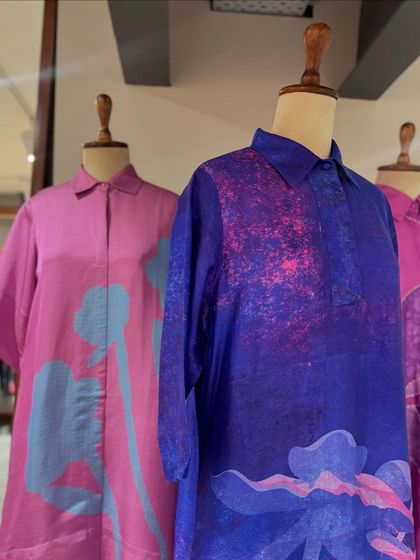 A trio of artistic dresses in shades of purple and pink, featuring abstract floral and textured prints.