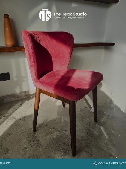 This simple yet elegant dining chair is upholstered in a striking pink velvet fabric. The armless design and tapered wooden legs make it a great choice for adding a pop of color without taking up too much space.