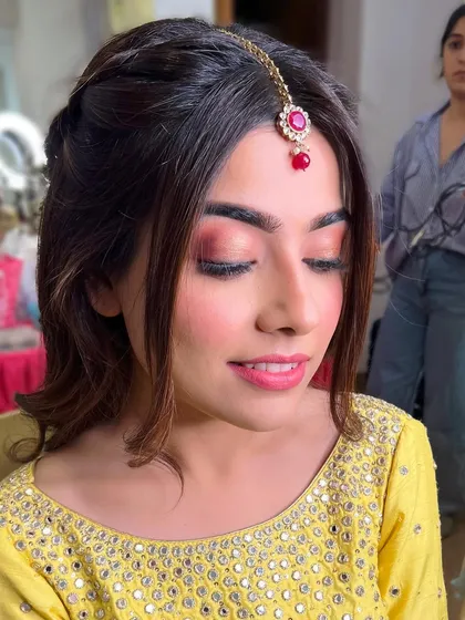 A close-up of the soft pink and coral eyeshadow for this Haldi look. The makeup is fresh, youthful, and perfect for a daytime event.