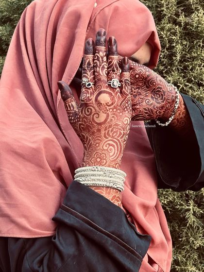 A modest and beautiful pose that highlights the rich mehendi stain. The color is deep and even, a perfect result from my organic henna.