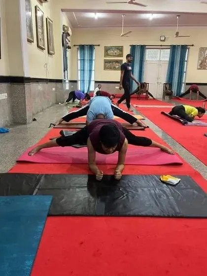This image from a group class shows students working on a deep hip-opening stretch. We focus on building flexibility through consistent and safe practice.