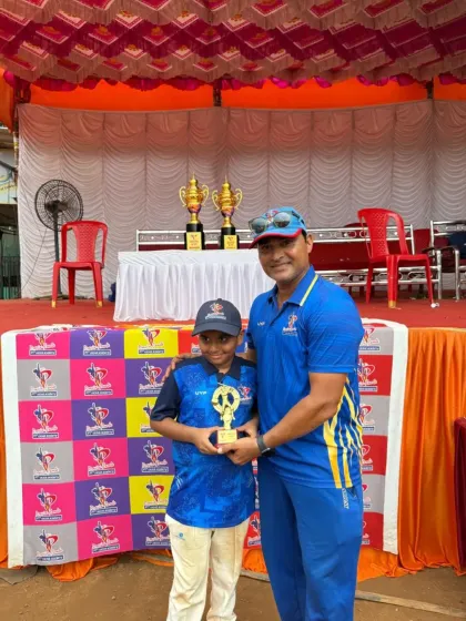 A young player in his team jersey receives an individual performance trophy during the PTPL awards ceremony.