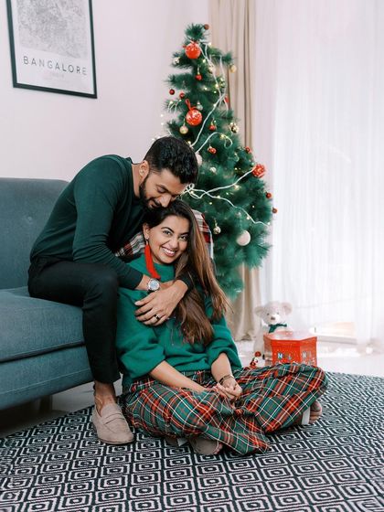 A cozy couple's portrait by the Christmas tree. A perfect way to capture the romance of the season.
