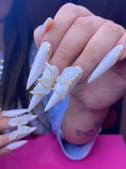 Here is another angle of the 3D butterfly nail set. You can see how the sculpted elements are secured for durability while maintaining a delicate, ethereal appearance, a key skill for advanced nail technicians.