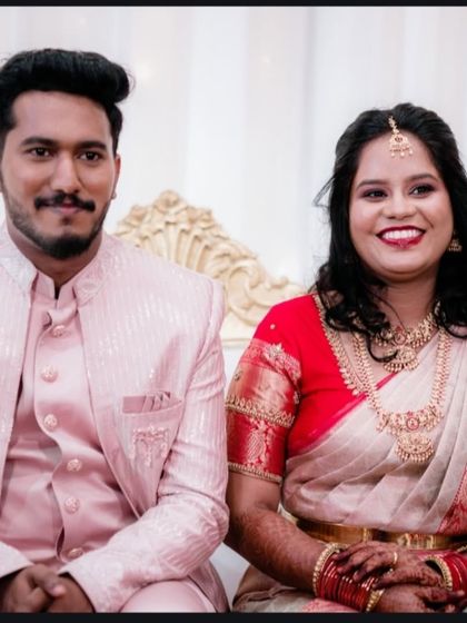 A classic seated portrait of the happy couple at their reception, looking bright and cheerful.