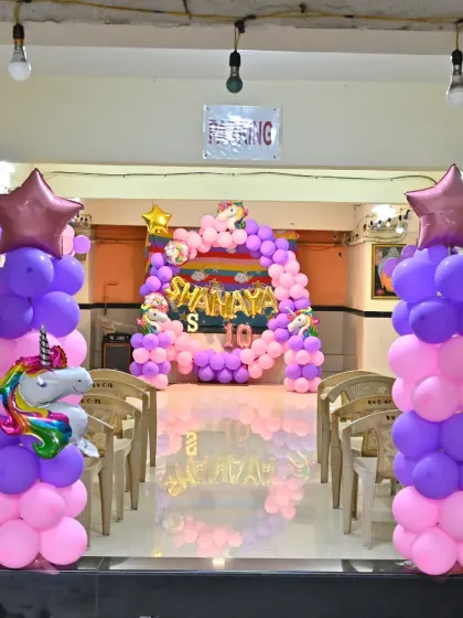 A view from the entrance of the party hall, showing the balloon pillars and the main backdrop.