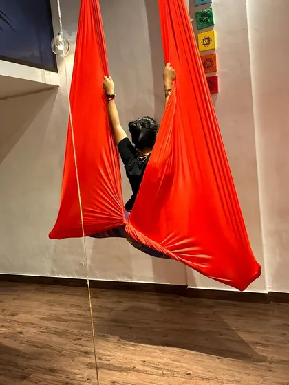 Finding bliss in any form of splits. Here, the hammock cocoons the body, providing a sense of security while allowing for a deep split stretch.