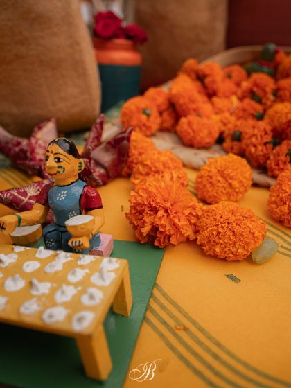 Another charming Channapatna toy, this one of a musician, placed next to a pile of fresh marigolds on the spice cart. These details highlight my commitment to supporting local artisans.