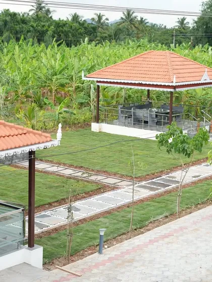 After: The same view, now a cohesive landscape. A lush lawn connects the main house to the gazebo, with neat stone pathways and newly planted trees beginning to define the space.