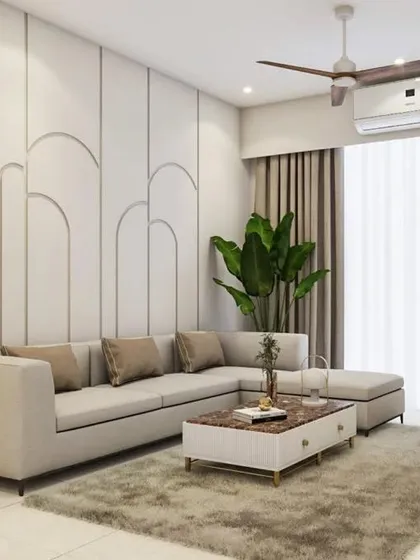 An example of minimalist elegance in a living room. The design features a comfortable L-shaped sofa, a simple yet stylish center table, and a feature wall with clean, curved molding for a subtle touch of sophistication.