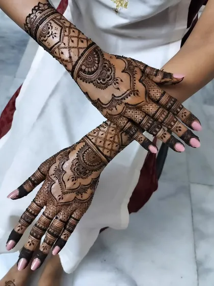 A different pose of the same elegant design, showcasing the beautiful patterns on the back of the hands. The clean lines and symmetrical look are perfect for an engagement or wedding.