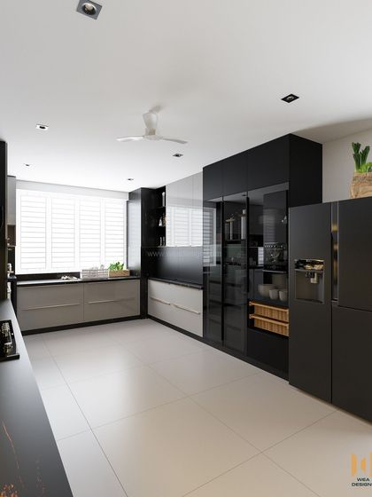A view of the kitchen's pantry and fridge wall, showcasing a mix of black and grey cabinets for a sophisticated, high-contrast look.