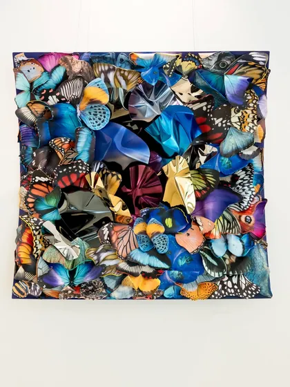 "Wings of Resilience" captures transformation through a fusion of butterfly forms and reflective metallic elements, creating a dynamic visual experience.