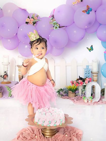 Ready to make a wish. This little one is celebrating her first birthday in style with a sparkly crown and a beautiful butterfly-themed setup.