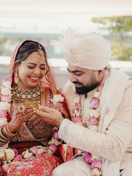 A sweet moment during a Maharashtrian wedding ritual. The bride's joyful smile as she participates in the ceremony is priceless.