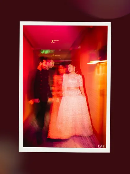 An abstract, motion-filled photograph from the couple's wedding reception. The vibrant red and orange light trails create a dreamlike effect, capturing the energy and excitement of the celebration in a unique and artistic way.