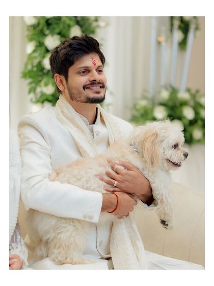 A lovely portrait of the groom with their pet, showcasing a sweet and personal side of their engagement day.