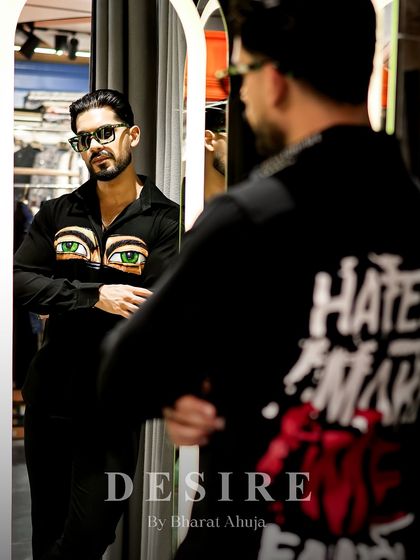 A profile view in the mirror, showing both the front and back of this statement shirt. It's a 360-degree work of art.