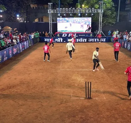 A wide-angle view of a match in progress at the DPL tournament. The large LED screen in the background shows live action, while the entire ground is evenly lit for perfect visibility.