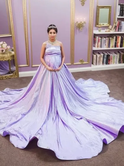 Feel like absolute royalty in our lilac iridescent ballgown. The magnificent trail spreads out to create a fairytale scene, making you the queen of your own story. This gown is perfect for an opulent indoor pregnancy photoshoot.
